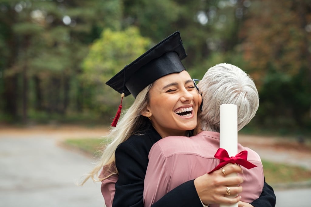 Graduate Girl Hugging Mother. Tuition-free college programs concept