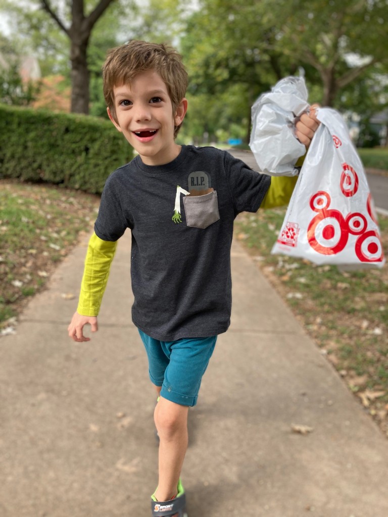 joss holds a target bag and smiles on a walk, for article on childhood fear