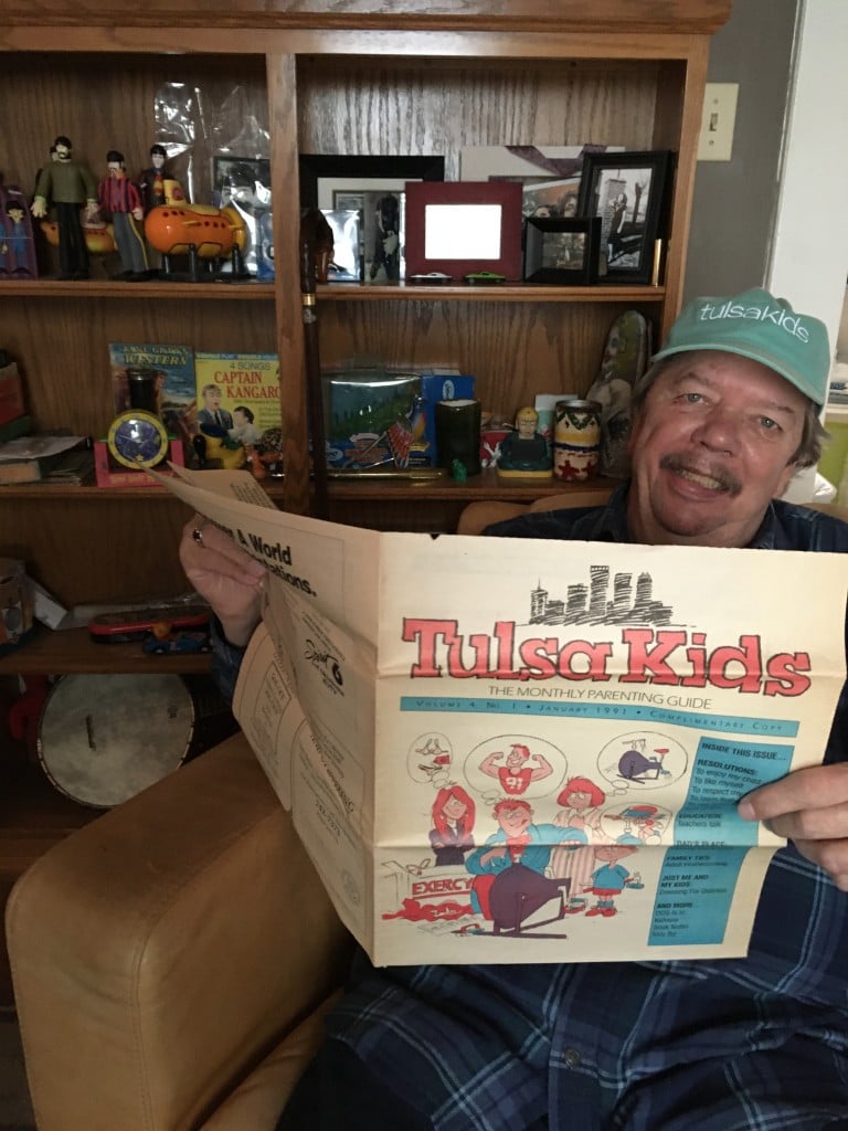 chuck foshee holds an early edition of tulsakids magazine