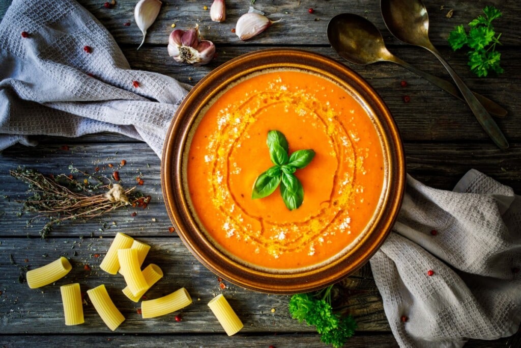 Cream Tomato Soup With Parmesan On Wooden Table