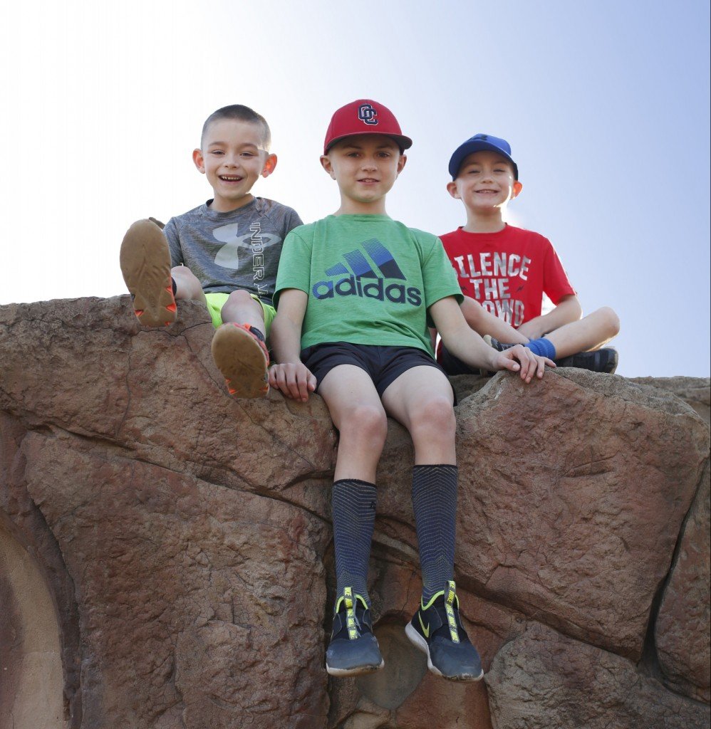 three boys on a boulder, for article on how to choose a summer camp