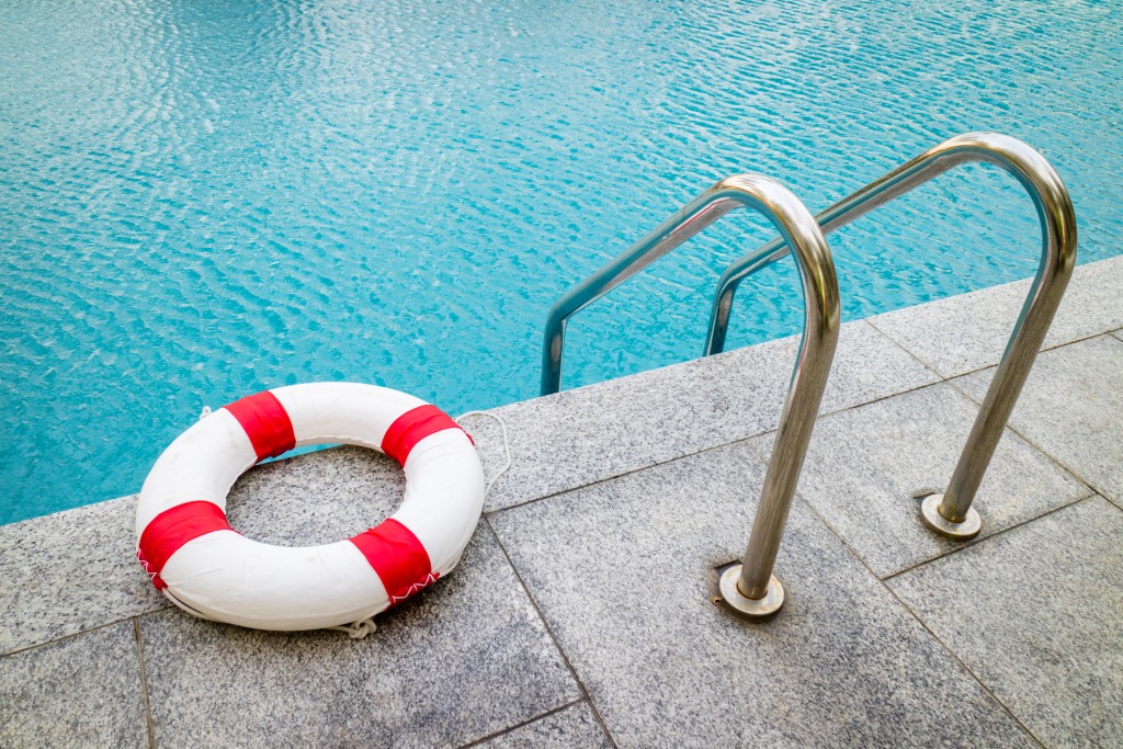 Life Ring At Swimming Pool.emergency Tire Floating At Swimming Pool.