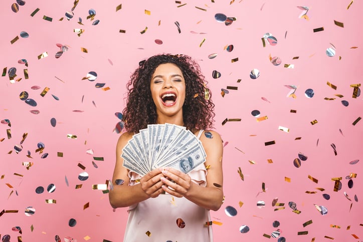 Black Afro American Girl Won Money. Happy Young Woman Holding Dollar Currency Satisfied Isolated Over Pink Background With Confetti.
