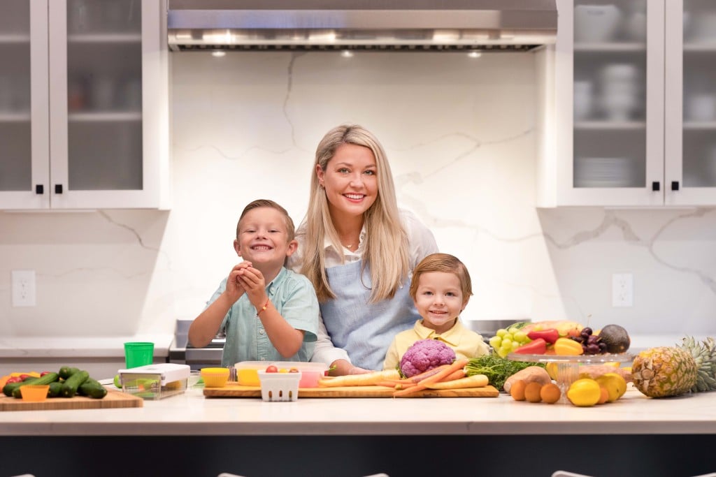 stephanie harris with her two young children in a kitchen