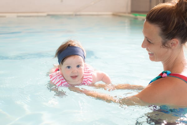 a baby and mom swimming, for article on swim lessons for babies