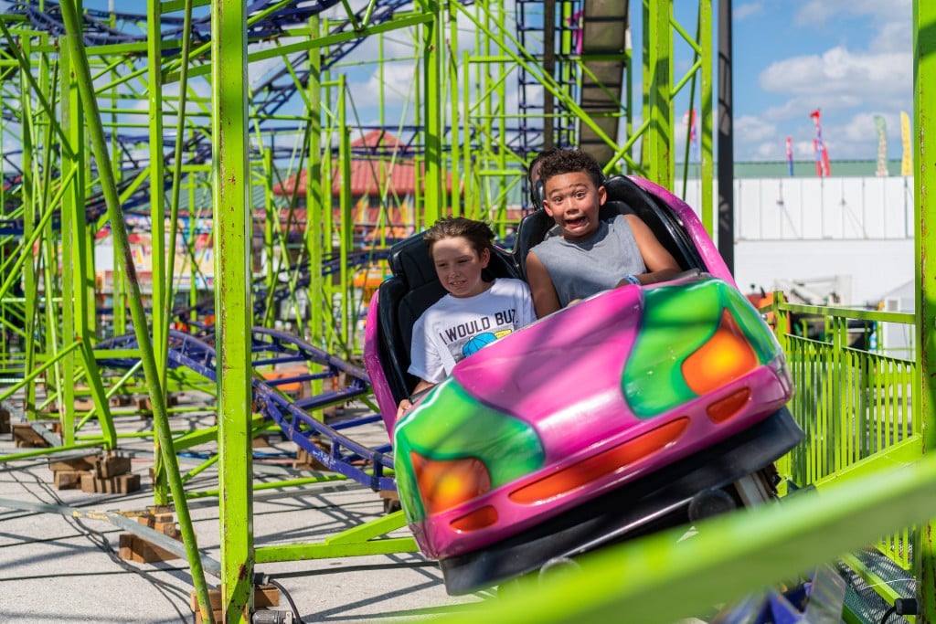kids riding a roller coaster at tulsa state fair