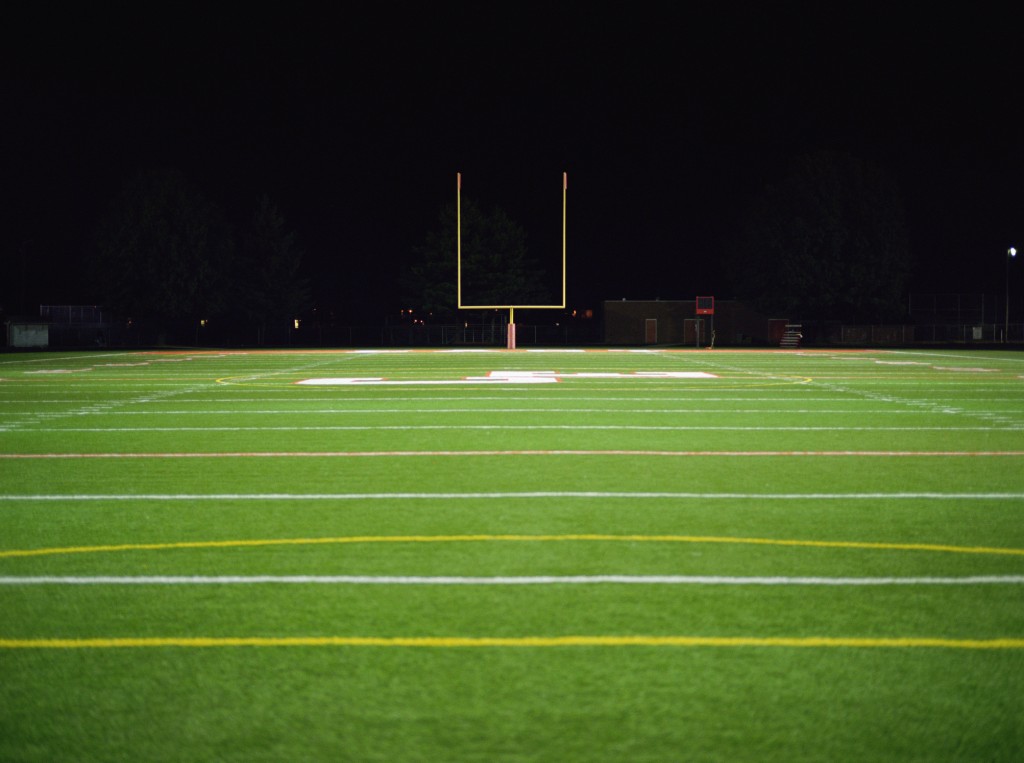 american football stadium at night, for article on the mclain high school shooting
