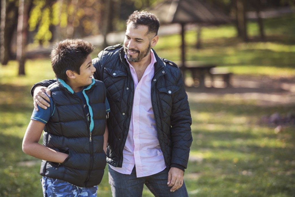 dad talks with tween son outside, for article on communicating with teens
