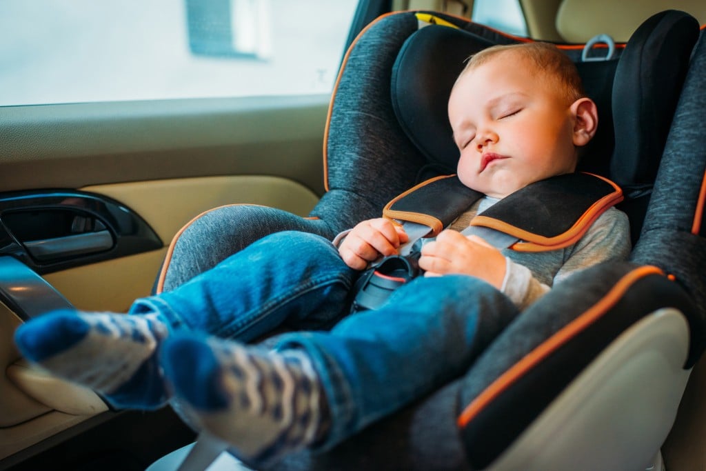Cute Little Baby Sleeping In Child Safety Seat In Car