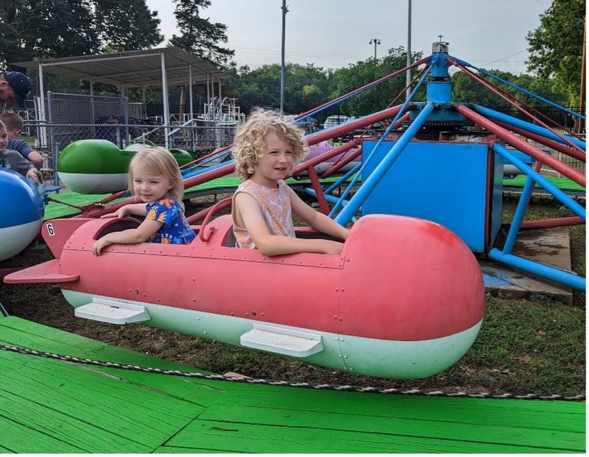 Callister and Sophia ride the planes at Bartlesville Kiddie Park