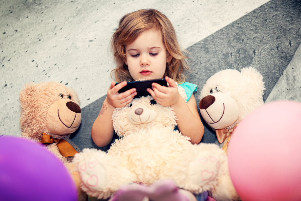 young girl using smartphone for article on screen time