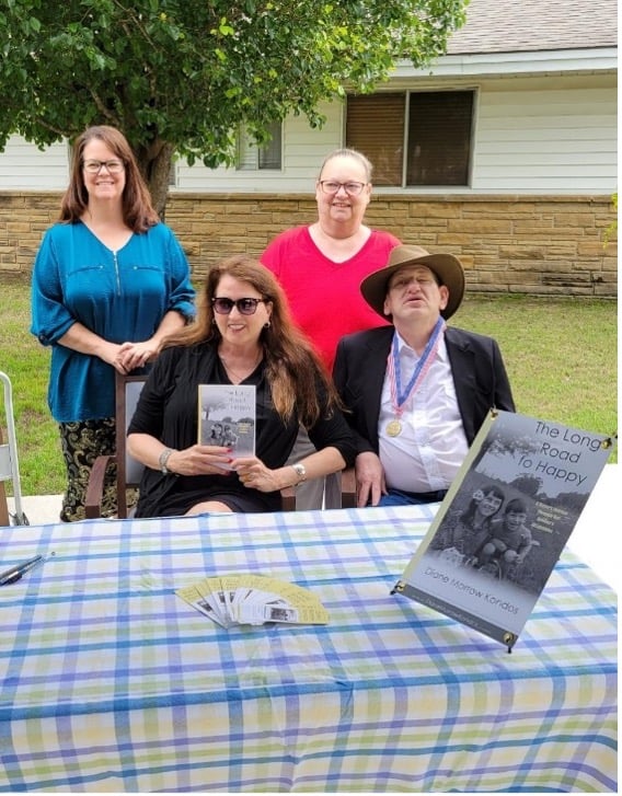 diane morrow kondos, her brother and staff at their book signing in celebration of national nursing home week