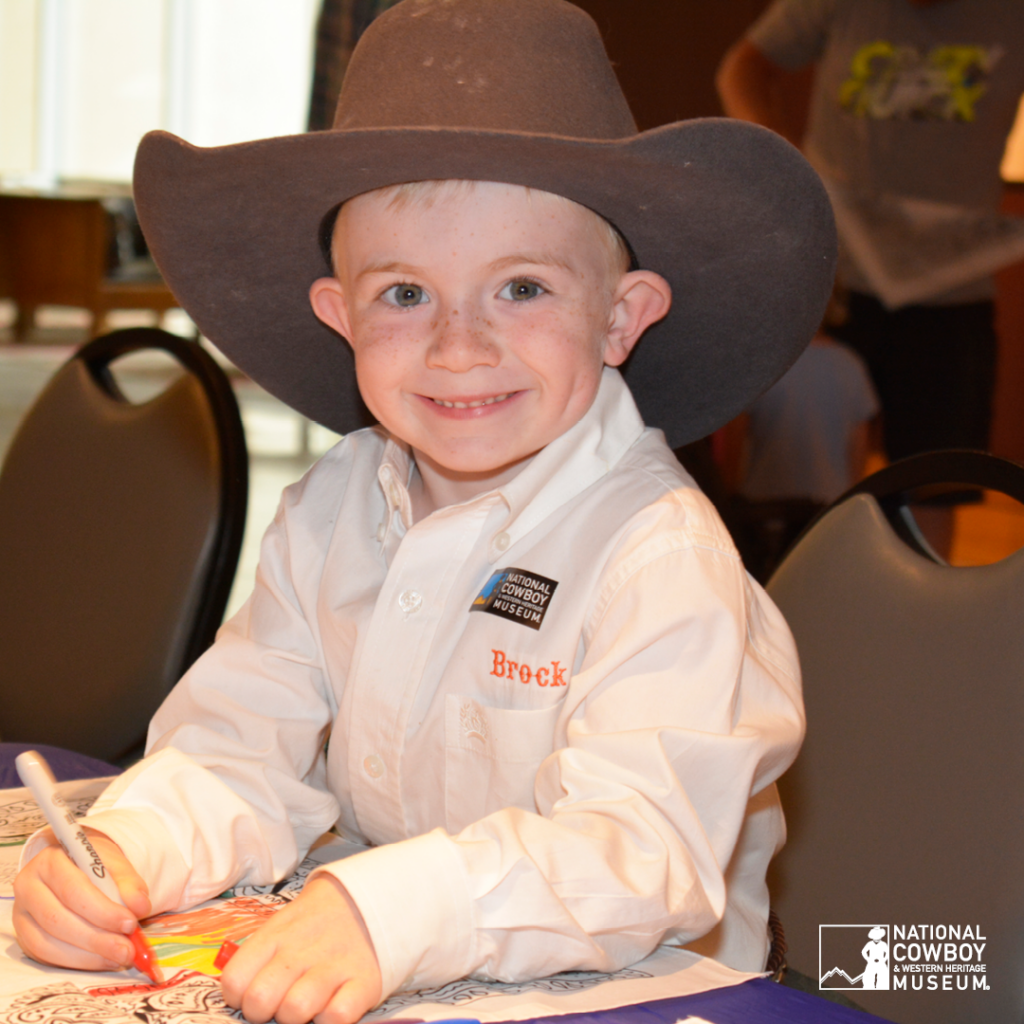 a child dressed in a cowboy hat enjoying national day of the cowboy