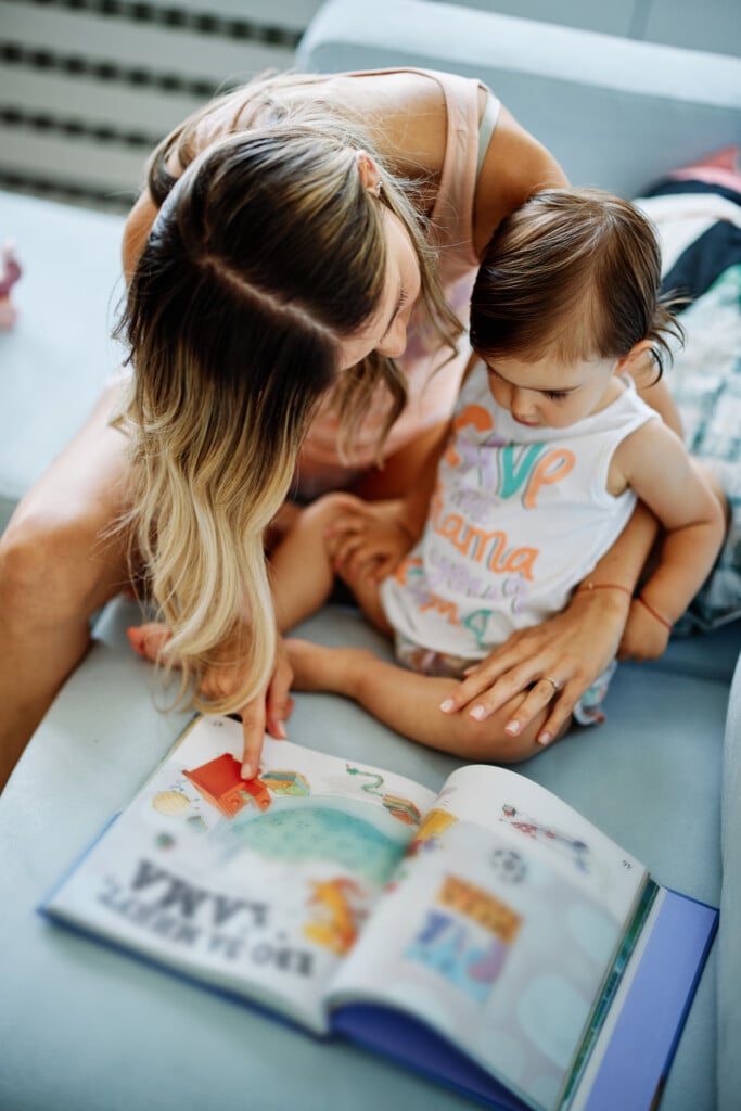 a mother reading a picture book with her baby, for article on early literacy