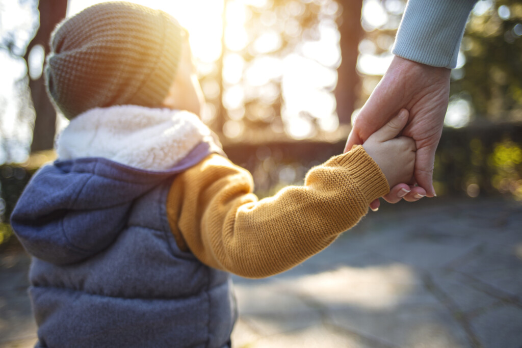 Close Up Of Mother And A Child Hands At The Sunset, for article on developmental delays