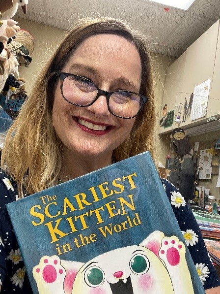 Melanie Palmer, South Broken Arrow Library Youth Librarian, holds a copy of The Scariest Kitten in the World