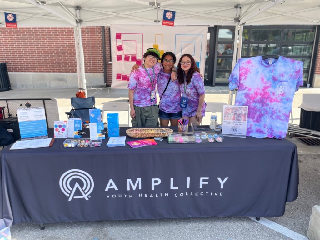 A group of students at an Amplify Youth Health Collective booth