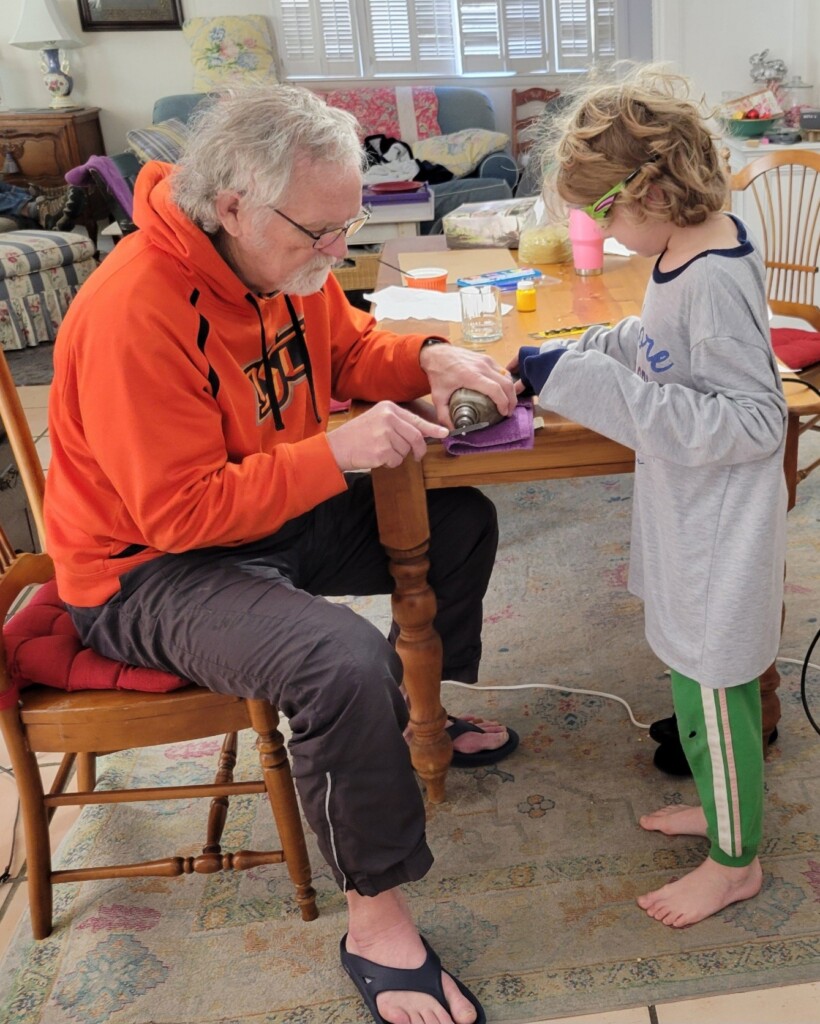 Steve and Callister working together on a Pinewood Derby car