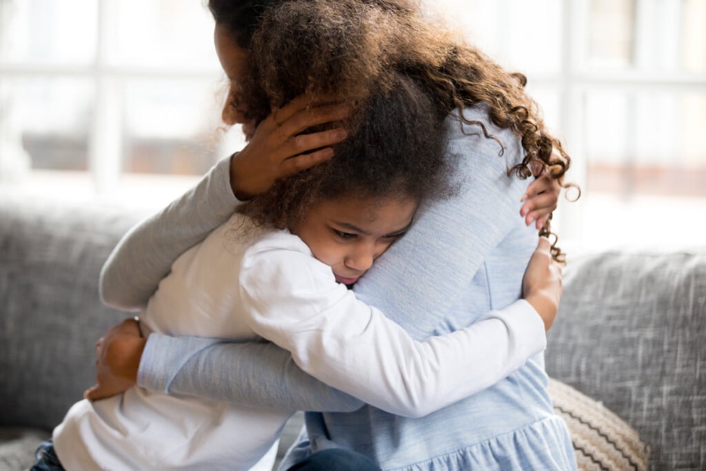 mother and daughter embracing, for article on helping young children feel secure