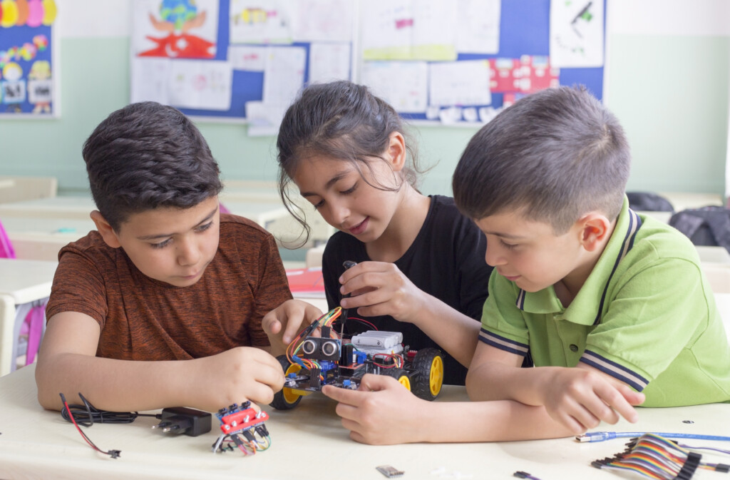 three students working on a robotics, for an article on learning styles