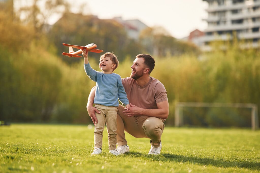 father and son with model airplane