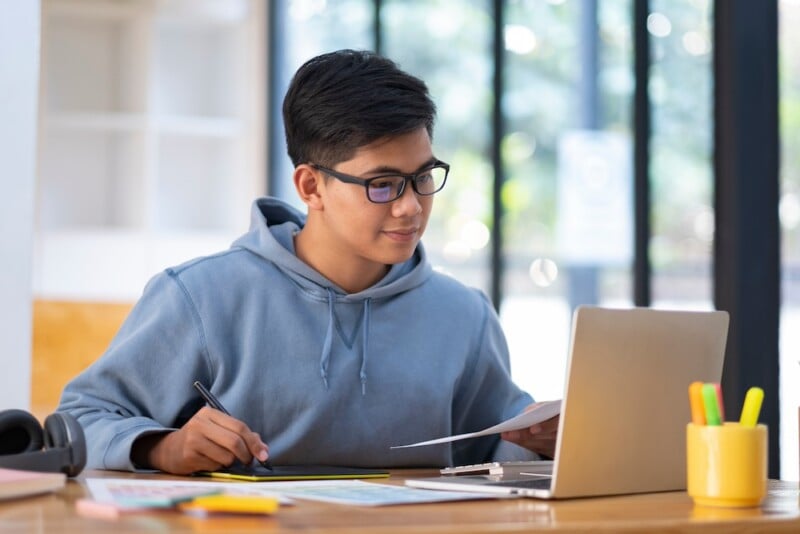 high school or college student using computer