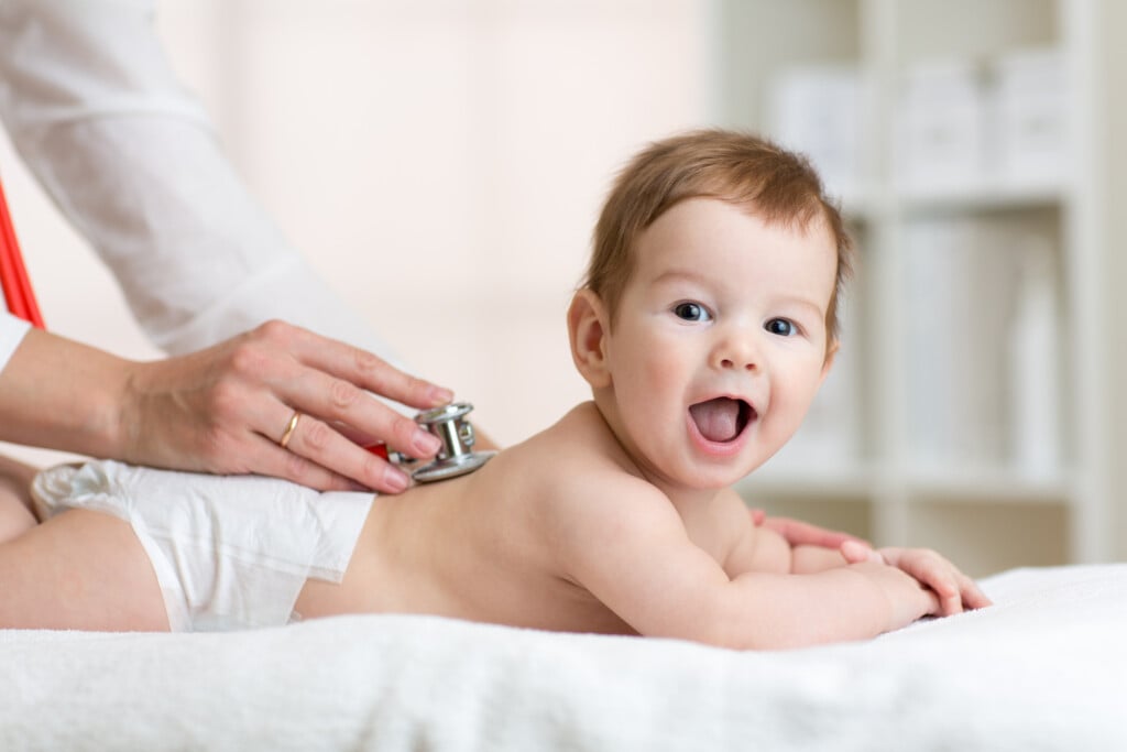 Pediatrician Examining Baby, for article on choosing a pediatrician