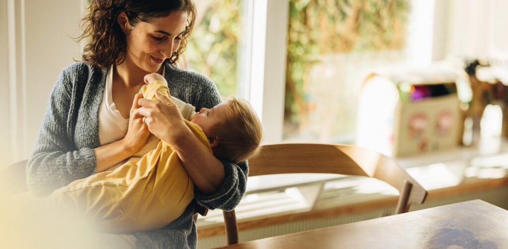 Loving Mother Feeding Baby With Bottle