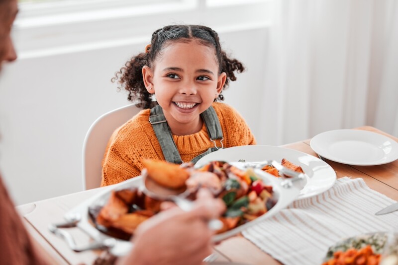 Child smiles at the dinner table
