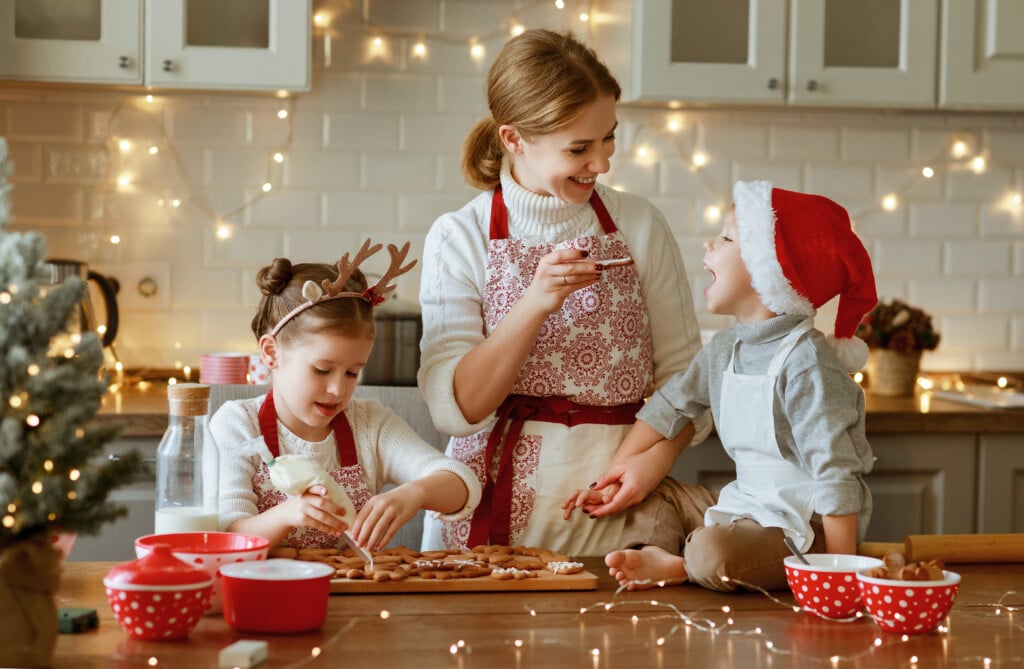 a mom and two kids making Christmas cookies