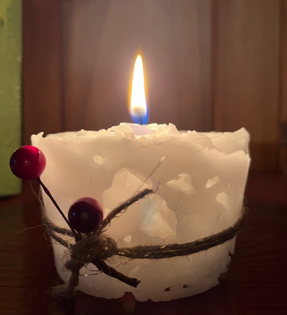 a festive ice candle, lit