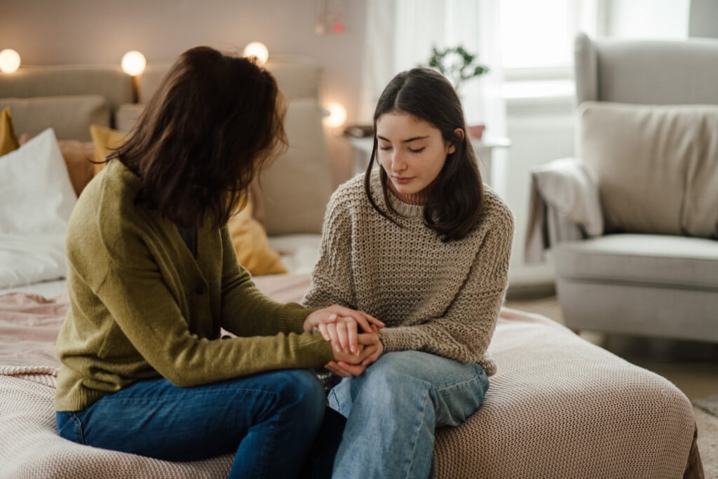 Teenage Girl Sharing Problems a female adult at home