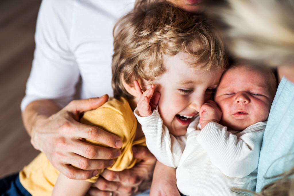 toddler with newborn sibling