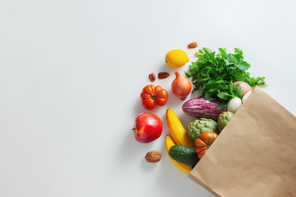 grocery bag with fresh produce spilling out, for article on childhood obesity