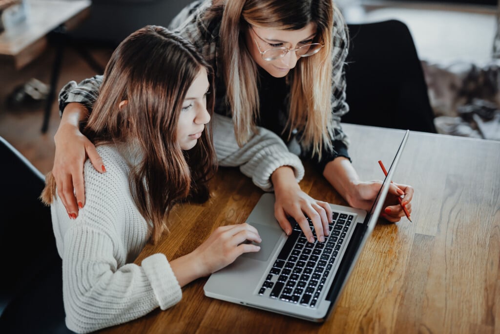 Mother And Child looking at laptop together