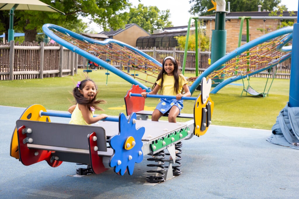two girls playing on a playground