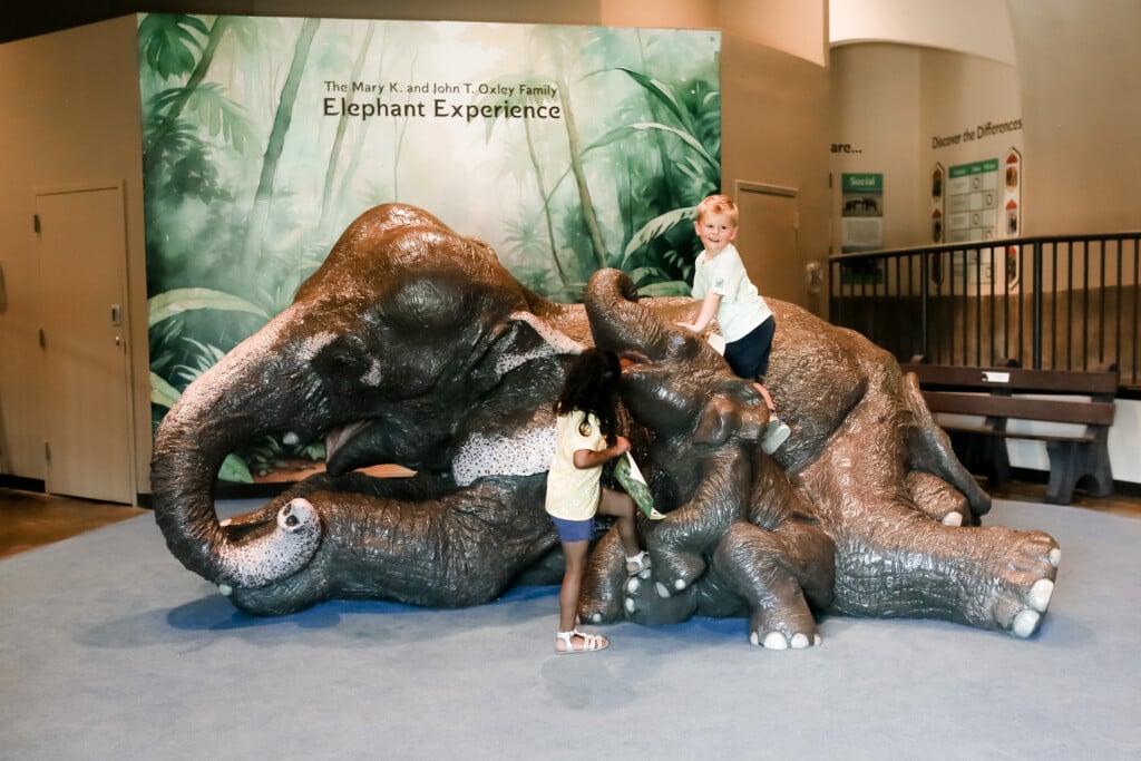 kids playing on the elephant statue at Tulsa Zoo