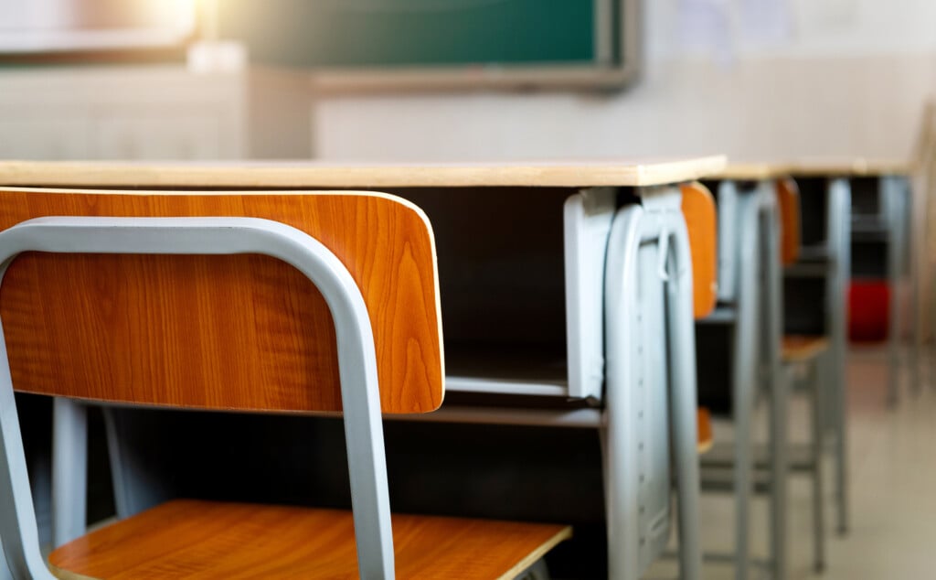 Empty Classroom With Chairs And Desks
