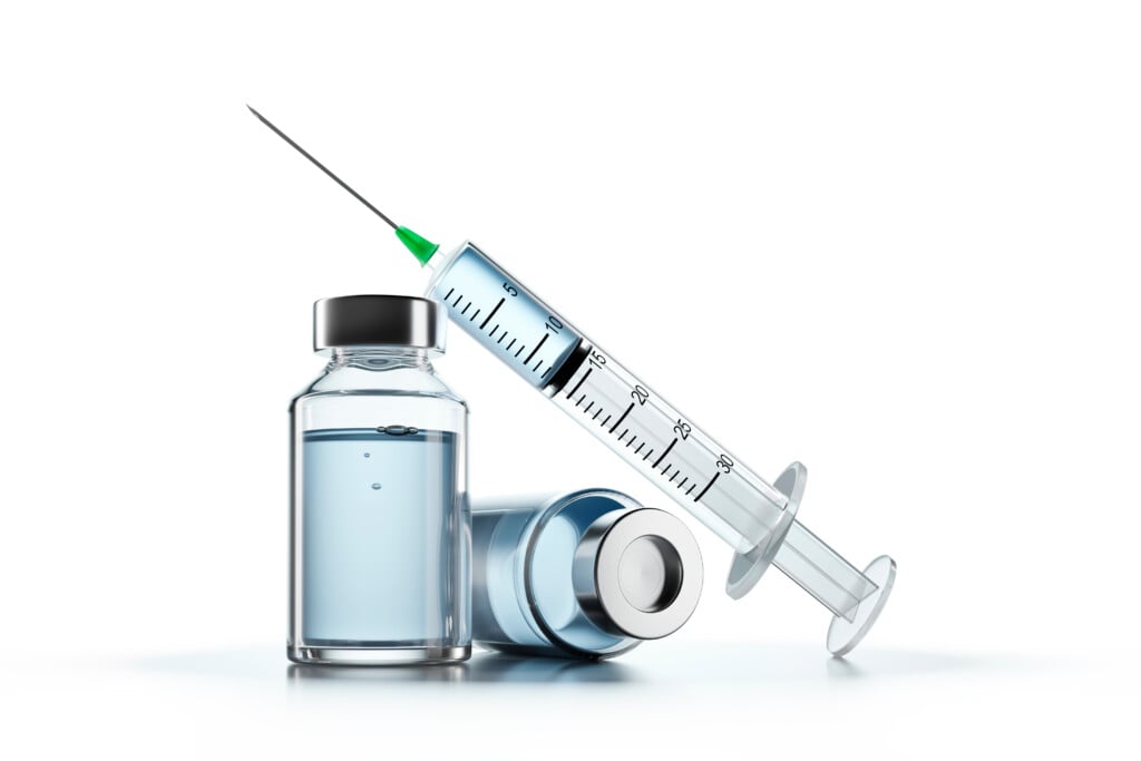 a vaccine needle and bottles, for article on vaccine myths