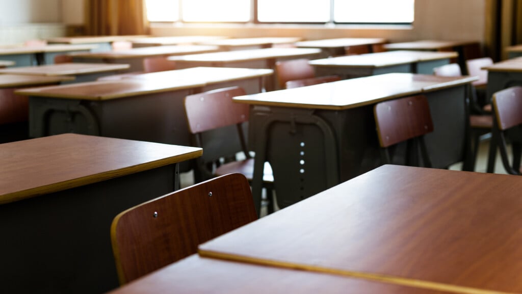 Empty Classroom With Chairs And Desks