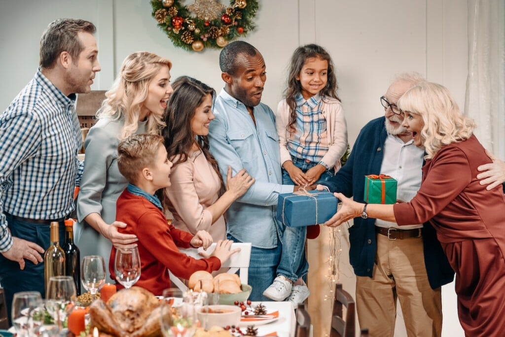 Grandparents Presenting Gifts To Family