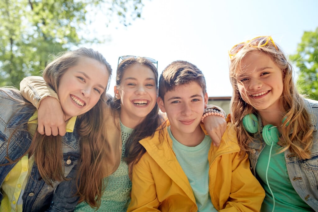 teens outside smiling