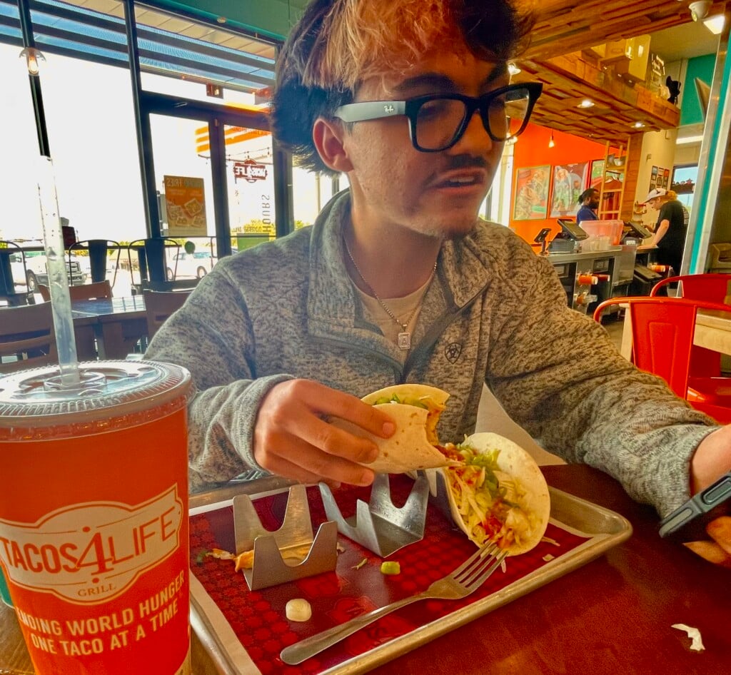 a teen eating at tacos4life