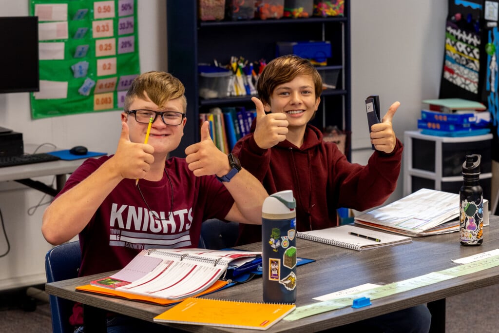 two town & country school students give a thumb's up