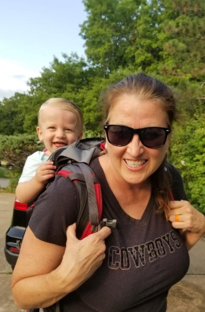 Diane Morrow-Kondos carries grandson Callister in a backpack