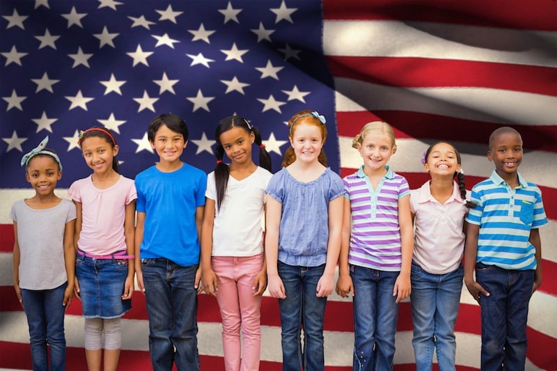 kids stand in front of u.s. flag, for article on kids and citizenship