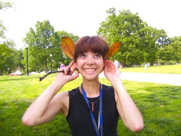 tara rittler holding magnolia leaves to her head, for article on college advice