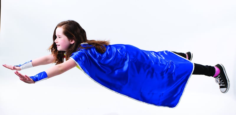 child dressed as superhero pretending to fly, for article on reporting child abuse