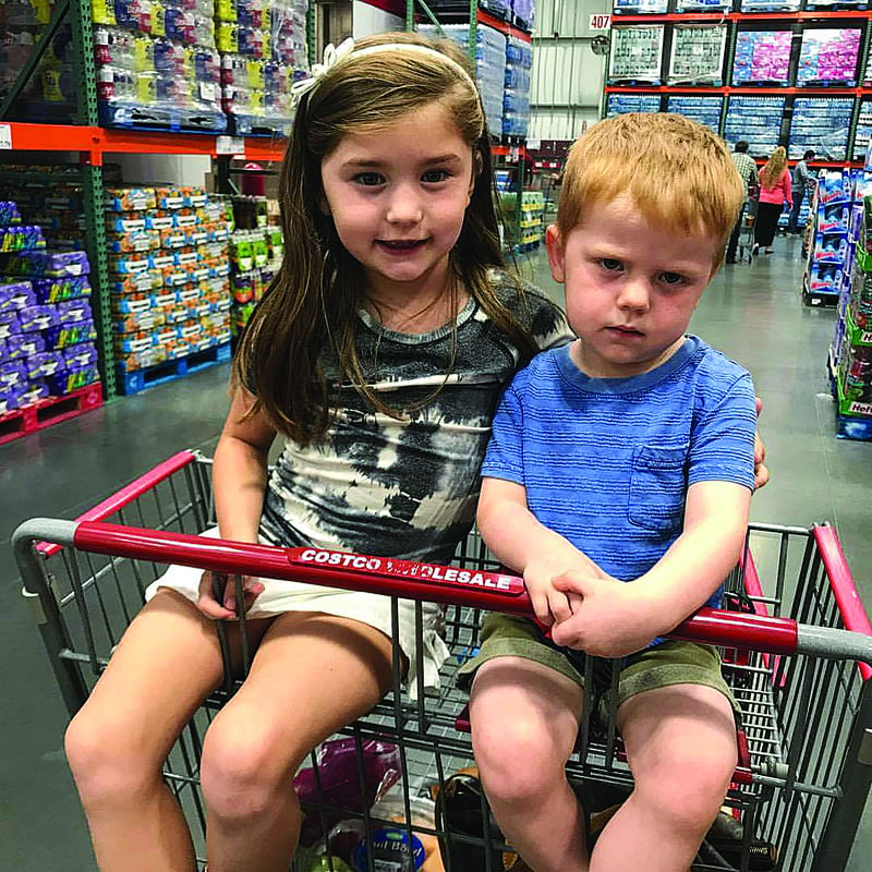 Child in cheap shopping trolley