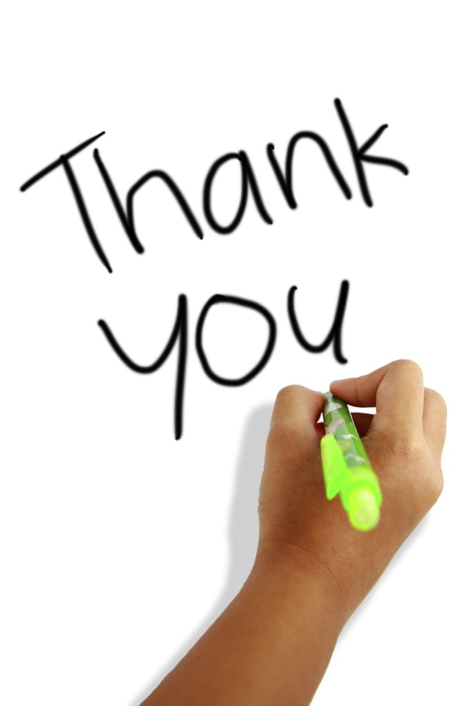 child's hand writing thank you, for article on thank-you notes